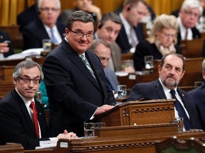 Canada's Finance Minister Jim Flaherty (2nd L) delivers the federal budget as Prime Minister Stephen Harper (R) looks on in the House of Commons on Parliament Hill in Ottawa on Tuesday. - REUTERS/Chris Wattie