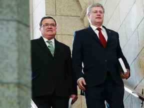 Prime Minister Stephen Harper (R) and Finance Minister Jim Flaherty walk to the House of Commons to deliver the budget on Parliament Hill in Ottawa on Tuesday, Feb. 11, 2014.     
REUTERS/Blair Gable
