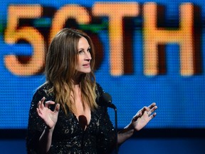 Actress Julia Roberts introduces the Beatles anniversary performance on stage for the 56th Grammy Awards at the Staples Center in Los Angeles, California, January 26, 2014. (AFP PHOTO FREDERIC J. BROWN)