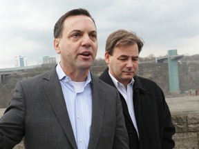 Ontario Progressive Conservative Leader Tim Hudak speaks to reporters about job losses in Niagara as Niagara Falls PC candidate Bart Maves listens. Mike DiBattista/QMI Agency)