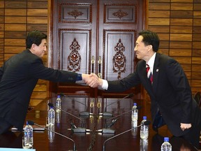 Head of the North Korean working-level delegation Park Yong-il (L) shakes hands with his South Korean counterpart Lee Duk-haeng during their talks.

REUTERS/Unification Ministry/Yonhap