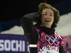 Switzerland's Iouri Podladtchikov celebrates after the men's snowboard halfpipe final at the Rosa Khutor Extreme Park during the Sochi Winter Olympics on February 11, 2014. (AFP PHOTO / FRANCK FIFE)