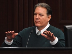 Defendant Michael Dunn gestures on the stand during testimony in his own defence during his murder trial in Duval County Courthouse in Jacksonville, Fla., February 11, 2014.   REUTERS/Bob Mack/Pool
