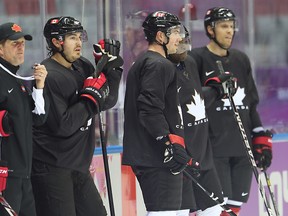 Team Canada head coach Mike Babcock (L) stands with Drew Doughty during hockey practice at the 2014 Olympic Winter Games in Sochi, Russia. (Al Charest/QMI Agency)