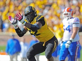 Missouri Tigers defensive lineman Michael Sam (52) celebrates after sacking Florida Gators quarterback Tyler Murphy (not pictured) during the first half at Faurot Field in Columbia, Missouri in this file photo from October 19, 2013.  According to media reports, Sam, who was the Southeastern Conference defense player of the year, announced publicly he was gay February 9, 2014, paving the way from him to perhaps be the NFL's first openly gay player. Mandatory Credit: Denny Medley-USA TODAY Sports  (UNITED STATES)