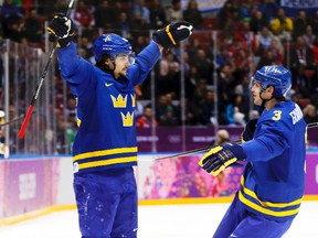 Sweden's Erik Karlsson (left) celebrates his goal with teammate Oliver Erkman-Larsson during their men's preliminary round hockey game against the Czech Republic at the Sochi 2014 Winter Olympic Games, Feb. 12, 2014. (MARK BLINCH/Reuters)