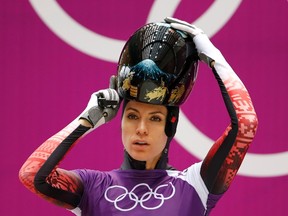 Canada's Mellisa Hollingsworth puts on her helmet for a women's skeleton training run at the Sanki Sliding Center at the Sochi 2014 Winter Olympics, Feb. 11, 2014. (FABRIZIO BENSCH/Reuters)