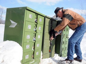 David Chambers took it upon himself to pick up his mail from the depot after not receiving any in his community mailbox for more than a week. - JANET RICHARDS/The Intelligencer