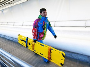 A member of the medical staff holds a stretcher at the Sanki sliding Center in Rosa Khutor, Russia, Feb. 13, 2014. (MURAD SEZER/Reuters)