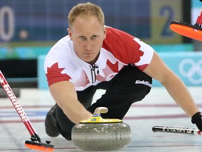 Canada's Brad Jacobs delivers a stone during the men's curling round robin game against Russia at the 2014 Winter Olympics in Sochi, Russia, Feb. 12, 2014. (AL CHAREST/QMI Agency)