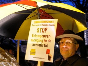 A protester holds up a sign during a demonstration against a new law authorizing euthanasia for children, in Brussels February 11, 2014.  REUTERS/Laurent Dubrule