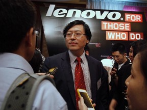 Lenovo chairman and chief executive officer Yang Yuanqing is surrounded by journalists during a news conference on the company's annual results in Hong Kong May 23, 2013. REUTERS/Bobby Yip