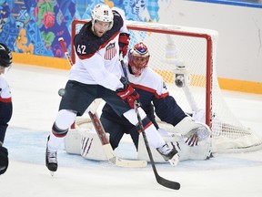 U.S. forward David Backes in front of Slovakia goalie Jaroslav Halak during their men’s hockey round-robin game at the 2014 Winter Games in Sochi, Russia, Feb. 13, 2014. (BEN PELOSSE/QMI Agency)