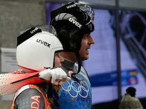 Calgary's Sam Edney and Alex Gough watch the scoreboard together during the luge relay team event at the Sanki Sliding Center, in Sochi, Russia, on Thursday February 13, 2014, (Didier Debusschere/QMI Agency)