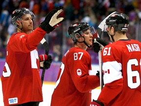 Canada's Sidney Crosby (C), Ryan Getzlaf (L) and Rick Nash react after defeating Norway in their men's preliminary round ice hockey game at the 2014 Sochi Winter Olympics, February 13, 2014. REUTERS/Gary Hershorn