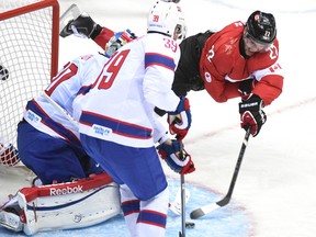 Canada's Jamie Benn goes flying during an Olympic men’s hockey game against Norway on Feb. 12. (Ben Pelosse, QMI Agency)