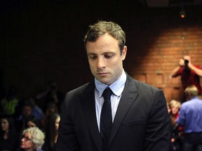 Oscar Pistorius, accused of murdering his model girlfriend Reeva Steenkamp, stands during court proceedings at the Pretoria Magistrates court on Aug 19, 2013. (Siphiwe Sibeko/Reuters/Files)