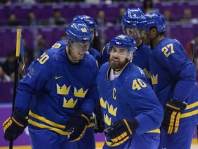 Sweden's Henrik Zetterberg (C) celebrates with teammates after scoring during the against the Czech Republic on Feb. 12. (AFP PHOTO / JONATHAN NACKSTRAND)