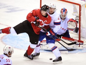 Team Canada's captain Sidney Crosby is checked in front of the net by Team Norway's Henrik Odegaard during the third period of their men's ice hockey game at the Bolshoy Ice Dome in Sochi, Russia, on Thursday, Feb. 13, 2014. (Ben Pelosse/QMI Agency)