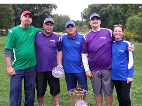 St. Thomas businessman Sean Gallagher, left, stands with professional disc golfers Jamie Pay, Brian Farquhar, Dave Northrup and his wife Nichole Rooyakkers in front of a disc golf basket. Gallagher and Rooyakkers have organized the city's first indoor disc golf putting league, which aims to help competitors improve their short games during winter. Submitted photo