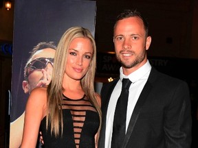 Oscar Pistorius, right, and his girlfriend Reeva Steenkamp pose for a picture in Johannesburg, February 7, 2013. (REUTERS/Thembani Makhubele)