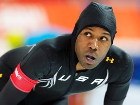 Shani Davis of the U.S. looks at his time after competing in the men's 1,000-metre speed skating race during the 2014 Sochi Winter Olympics, Feb. 12, 2014.  (PHIL NOBLE/Reuters)