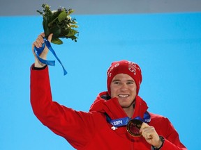 Gold medallist Switzerland's Dario Cologna poses during the victory ceremony for the men's cross-country 15km classic event at the 2014 Sochi Winter Olympics February 14, 2014. (REUTERS)