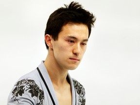 A sombre looking Patrick Chan skates on the ice before the start of his routine during the Sochi 2014 Winter Olympics men's figure skating free  skate in Sochi, Russia, Feb. 14, 2014. (AL CHAREST/QMI Agency)