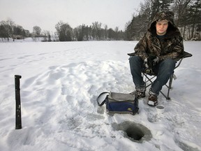 Jeff Tribe/TILLSONBURG NEWS
Layn Wells brought along a machete to open up existing ice fishing holes Sunday afternoon on Lake Lisgar.
