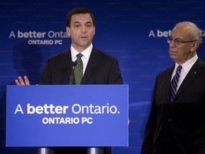 Ontario PC leader Tim Hudak, with his then-finance critic Peter Shurman, speaks to the media about the Liberals’ provincial budget last May. Shurman has since left the party and recently described the Tories under his former boss as a “nightmare.”  Hudak will need to unite his party to be able to compete for the votes of Ontarians.
JACK BOLAND/TORONTO SUN FILES