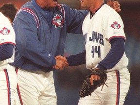 Former Blue Jays manager Jim Fregosi congratulates Billy Koch. Fregosi died on Feb. 14. (Reuters file)