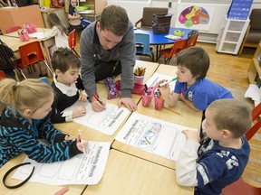 Aberdeen principal Cindy Kissau is credited with being largely responsible for turning Aberdeen around. Here, Grade 1-2 teacher Kevin Turcot works with pupils in the classroom. (CRAIG GLOVER, The London Free Press)