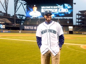 Robinson Cano dons a Mariners jersey for the first time and poses at Safeco Field, which won't be as kind to him as Yankee Stadium. (Getty Images)
