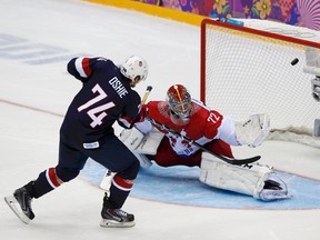 Team USA's T.J. Oshie scores on the team's sixth shootout attempt against Russia's goalie Sergei Bobrovski during their men's preliminary round ice hockey game at the Sochi 2014 Winter Olympic Games. (REUTERS)