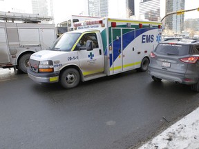 Ambulance leaves the scene of a pedestrian collision at 10 ave and 5 st s.w. in Calgary, Alta., on Thursday February 13, 2014. Mike Drew/Calgary Sun/QMI Agency
