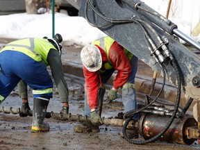EPCOR crews use a drill to attempt to repair a water main break near 124 Street and 108 Avenue in Edmonton, Alta., on Friday, February 15, 2013. Dozens of businesses and homes in the area were affected after the early morning break. Ian Kucerak/Edmonton Sun/QMI Agency
