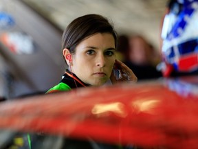 Danica Patrick, driver of the #10 GoDaddy Chevrolet, stands in the garage area during practice for the NASCAR Sprint Cup Series Daytona 500 at Daytona International Speedway on February 15, 2014 in Daytona Beach, Florida. (Jamie Squire/Getty Images/AFP)