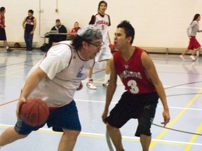 Barnaby Provost tries to blow by his own player and student during the third-quarter of the PNSS student vs. teacher classic. Greg Cowan photo/QMI Agency.