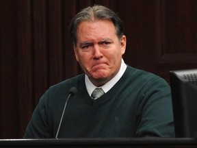 Defendant Michael Dunn reacts on the stand during testimony in his own defense during his murder trial in Duval County Courthouse in Jacksonville, Florida February 11, 2014.  Dunn is accused of first degree murder in death of unarmed teenager Jordan Davis after an altercation over loud rap music at a Florida gas station in November 2012.  REUTERS/Bob Mack/Pool