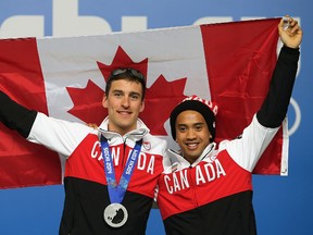 Canadian long-track speed skaters Denny Morrison (left) Gilmore Junio during a press conference at the 2014 Winter Olympics in Sochi, Russia, Feb. 16, 2014. (AL CHAREST/QMI Agency)