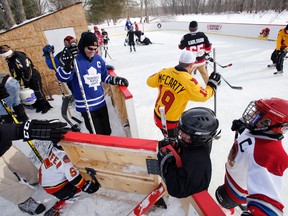 There is plenty of Family Day weekend fun to score for those playing pick up hockey on Derrick Swoffer's (centre, with yellow jersey) backyard rink at his River Road residence in Corbyville, Ont. Saturday, Feb. 16, 2014.  -  JEROME LESSARD/The Intelligencer