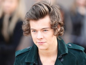 British singer Harry Styles from the band One Direction arrives to attend the presentation of the Burberry Autumn/Winter 2014 collection during London Fashion Week February 17, 2014. REUTERS/Olivia Harris