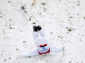 Canada's Travis Gerrits crashes during the men's freestyle skiing aerials qualification round at the 2014 Sochi Winter Olympic Games in Rosa Khutor, Feb. 17, 2014. (MIKE BLAKE/Reuters)