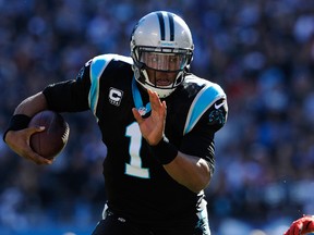 Cam Newton of the Carolina Panthers runs with the ball during the NFC Divisional playoff game against the San Francisco 49ers at Bank of America Stadium on January 12, 2014 in Charlotte, N.C. (Grant Halverson/Getty Images/AFP)