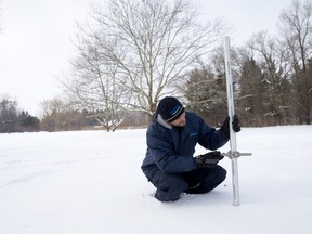 Brent Verscheure, superintendent for Pittock Conservation Area, takes a core sample to measure the depth of snow at one of several testing points near the Thames River in Fanshawe Conservation Area in London. The measurements, for which there are records dating back 50 years, can help predict runoff amounts when a thaw hits. (CRAIG GLOVER, The London Free Press)