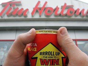 A Tim Hortons' "roll up the rim to win" coffee cup is pictured in this file photo. (DAVID BLOOM/Postmedia Network Agency)