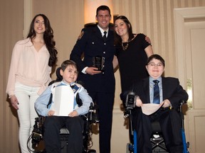 Sarnia firefighter Chris Ireland is shown receiving the Danielle Campo Extra Mile Award at a recent Muscular Dystrophy Canada conference in Toronto. The award is given to go-to fundraisers that go the extra mile for the organization. Also pictured is Muscular Dystrophy's Kerri Stocks, revenue development coordinator for southwestern Ontario, right, and event emcees Christina Massad, left, Owen McGonigal, and Alex Harrold. Those three are also clients with Muscular Dystrophy Canada. (Submitted photo)