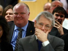 Toronto Mayor Rob Ford and Councillor Adam Vaughan listen to a public meeting at Central Technical School in Toront Thursday, January 9, 2014. (Dave Abel/Toronto Sun)
