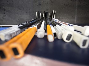 Hockey sticks against a wall. (Ian Kucerak/Edmonton Sun/QMI Agency)