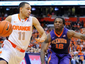 Syracuse Orange guard Tyler Ennis (left) dribbles the ball in front of Clemson Tigers guard Rod Hall during the first half at the Carrier Dome. (RICH BARNES/USA TODAY Sports)